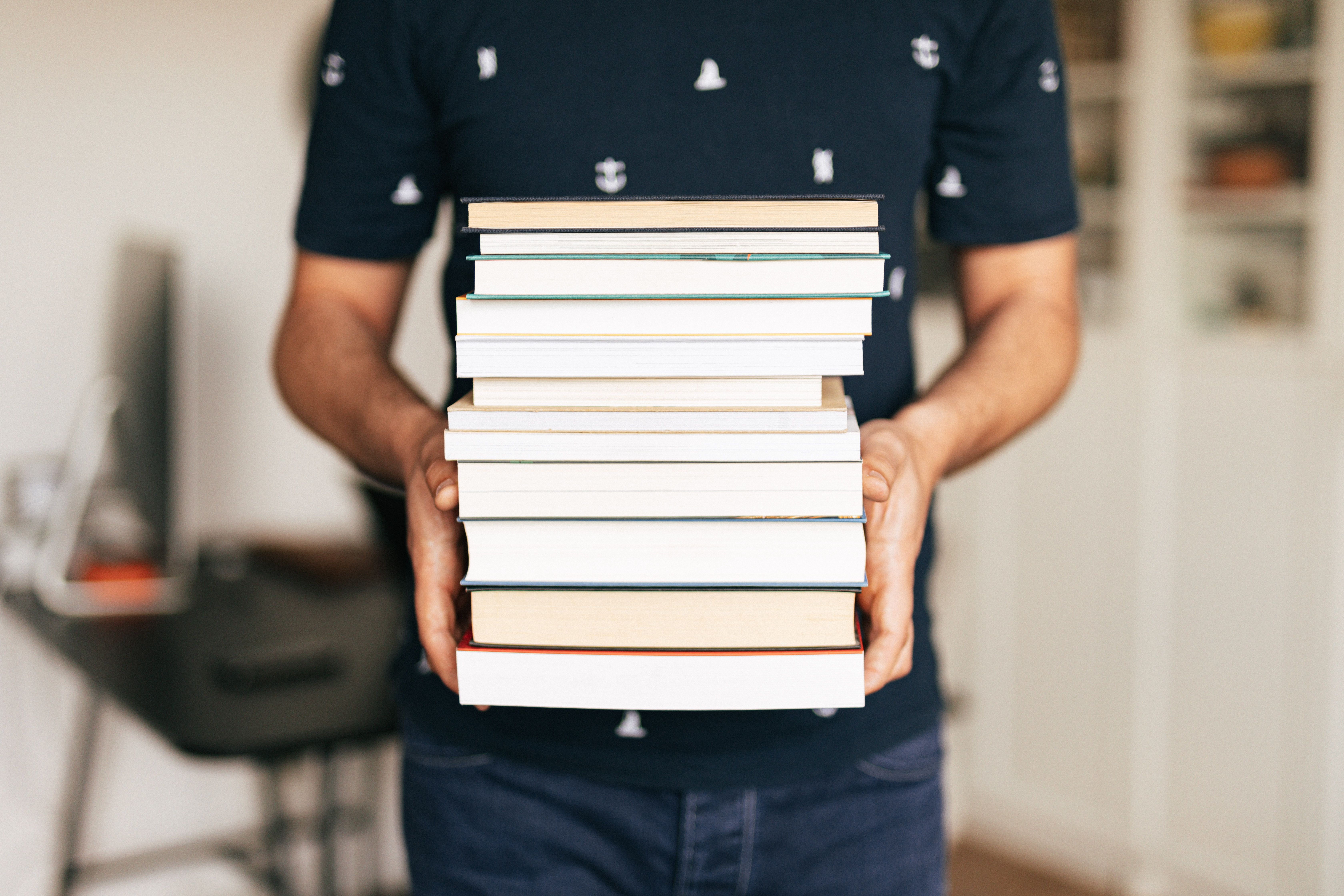 person carrying a stack of books.jpg